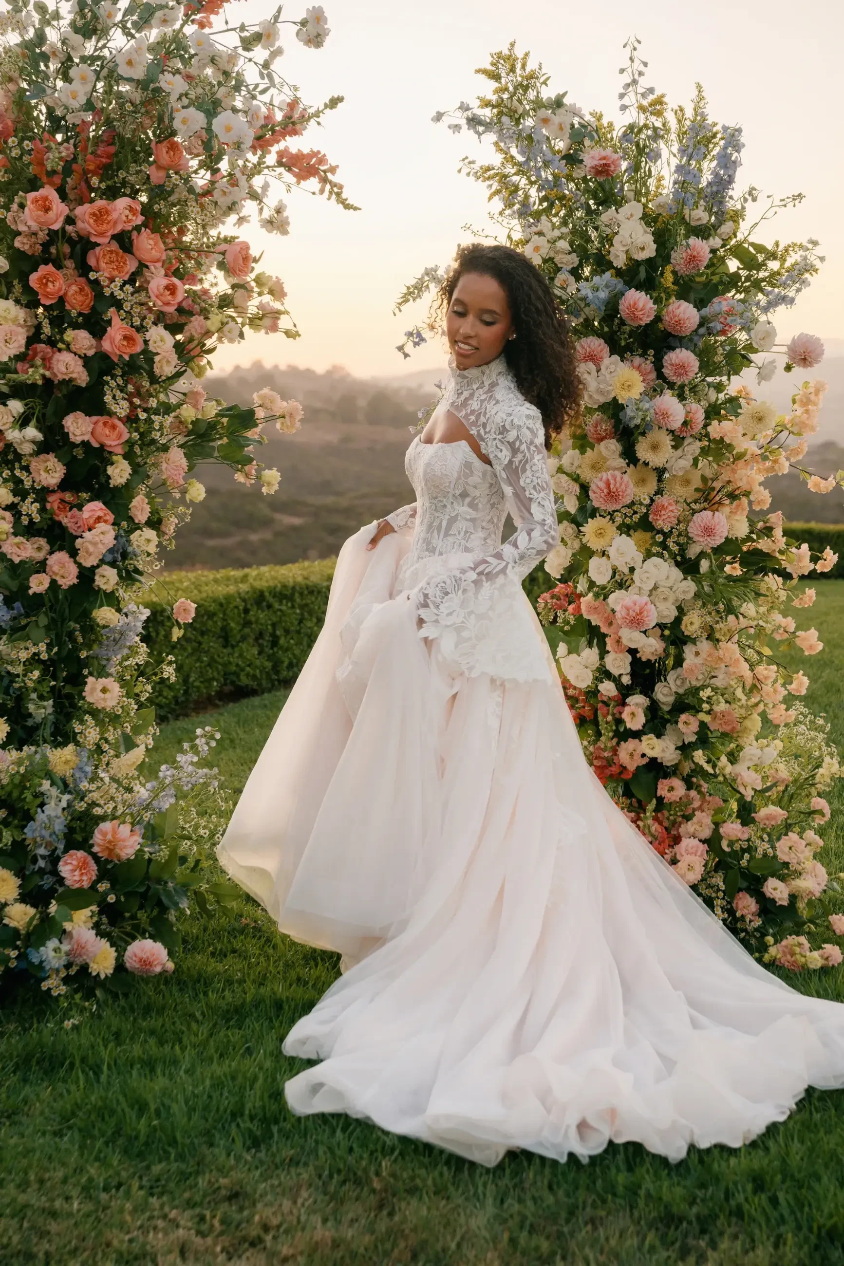 model is wearing an a-line wedding dress with a lace bridal jacket
