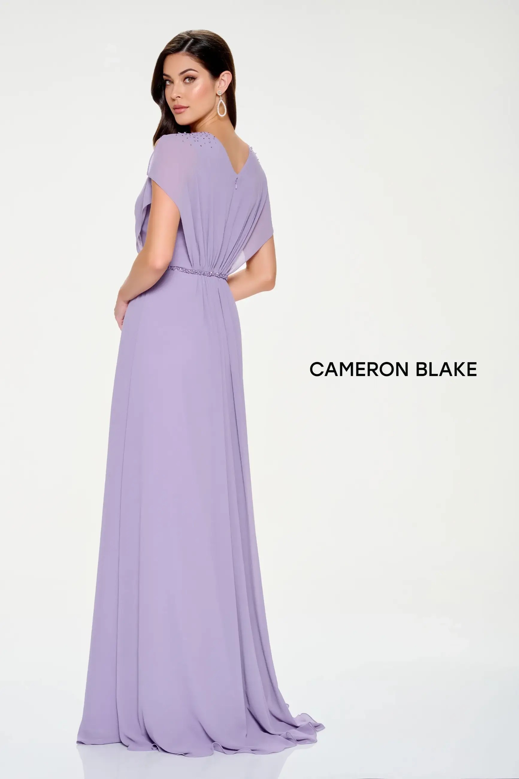 Model is wearing an a-line evening gown with a v-neckline and sparkling beaded belt by cameron blake