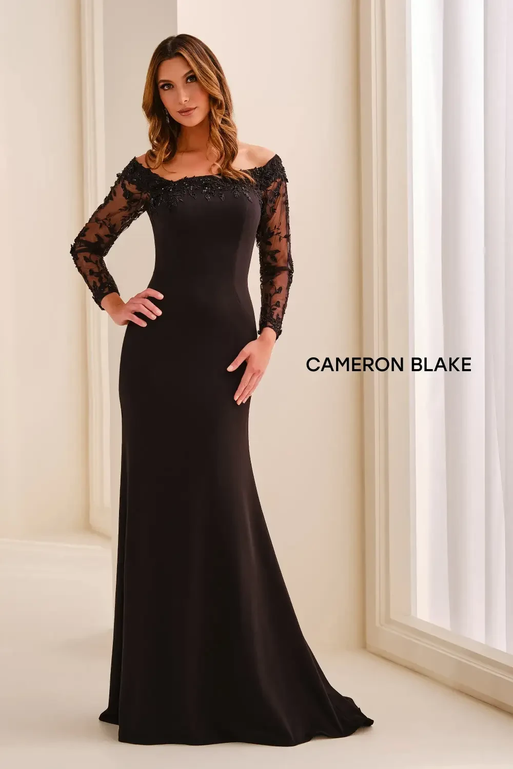 model is wearing a scoop neck black mothers gown