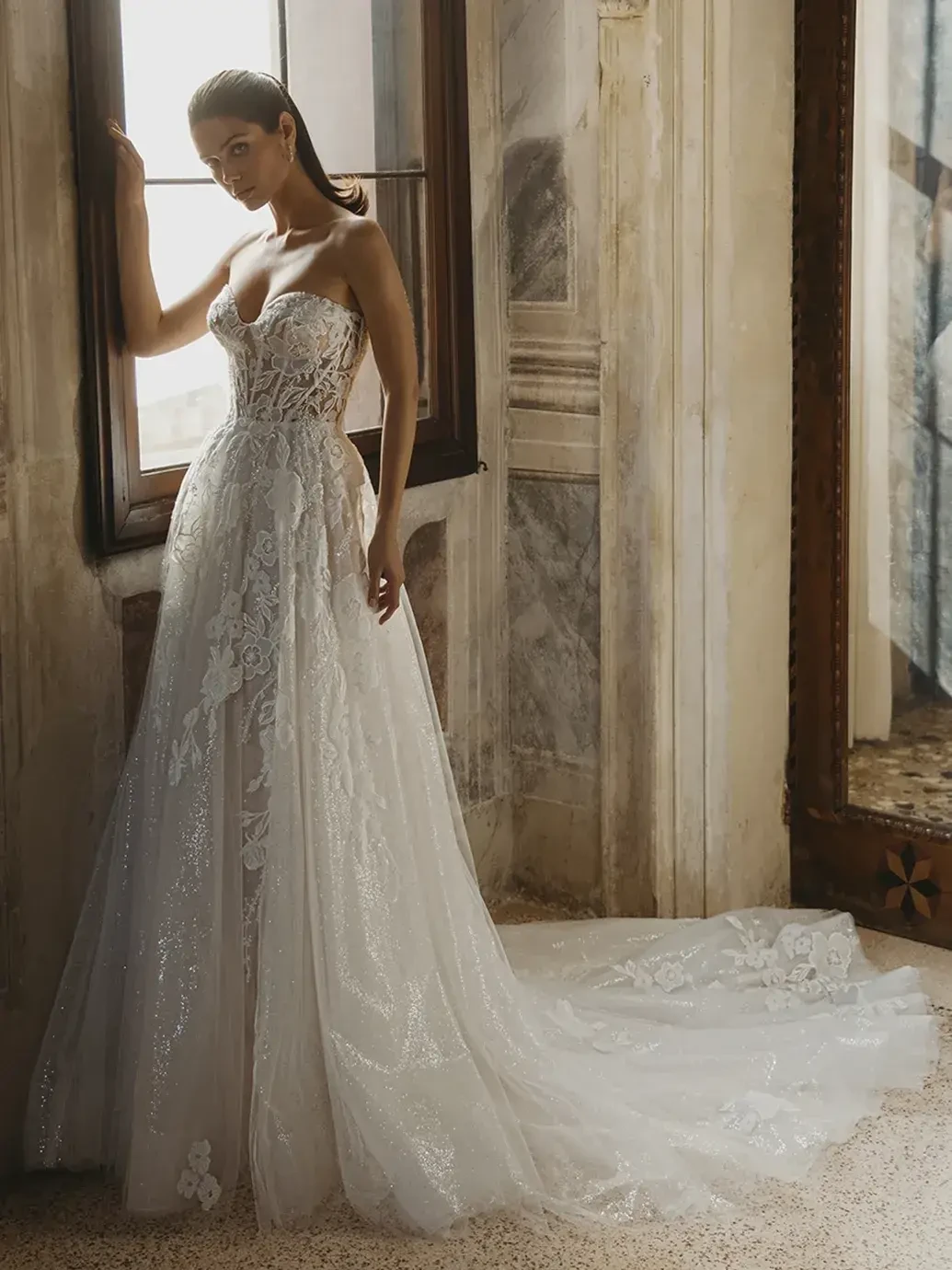 model is wearing a halter a-line wedding dress with 3d floral appliques