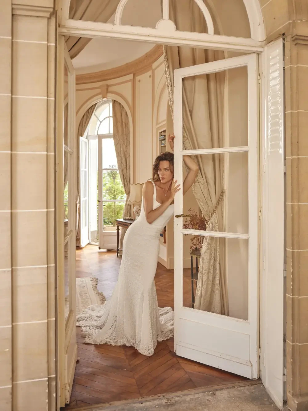 model is wearing an open back bridal gown