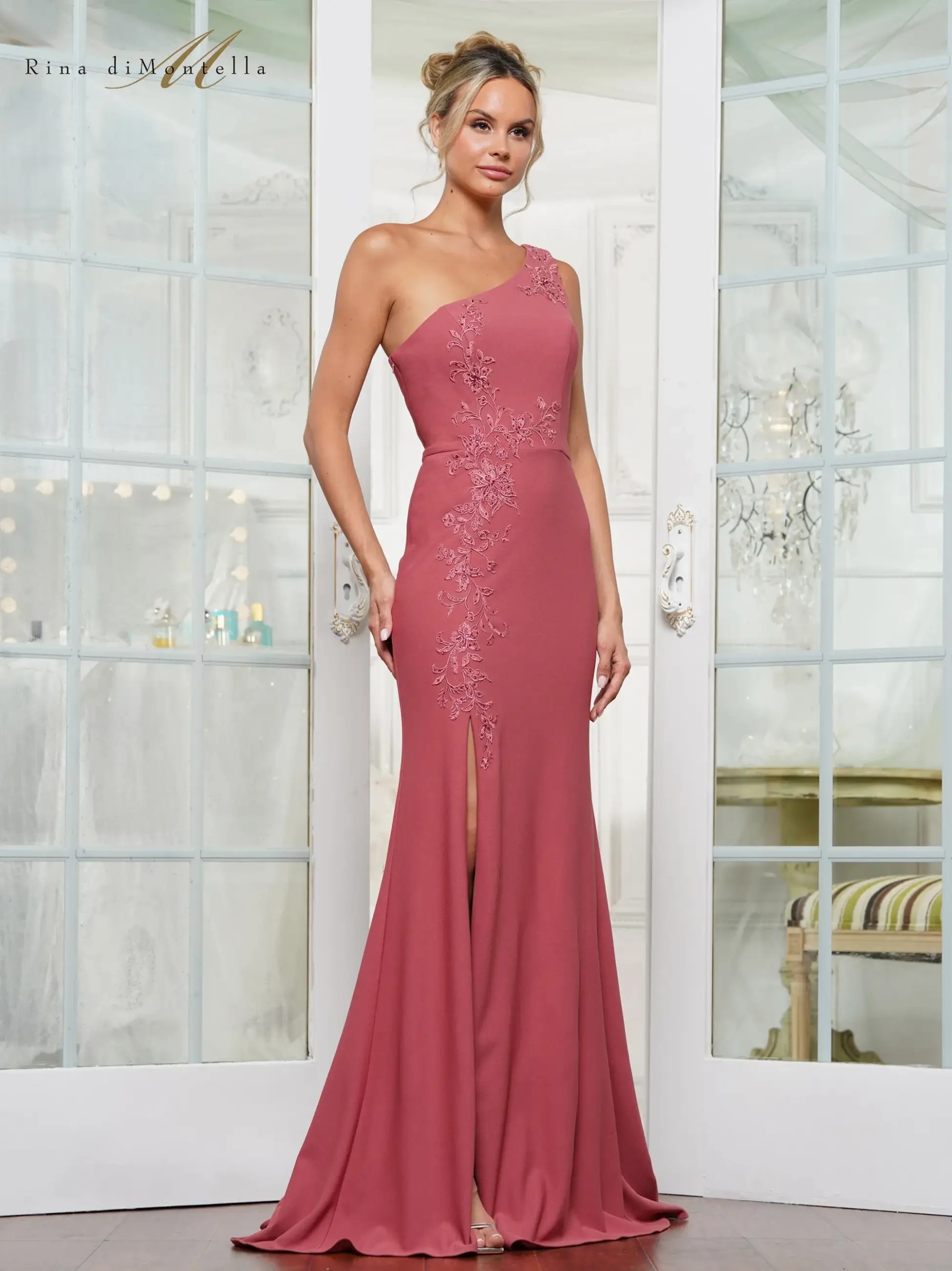 Model is wearing a column evening dress with one shoulder and a daring slit by rina di montella