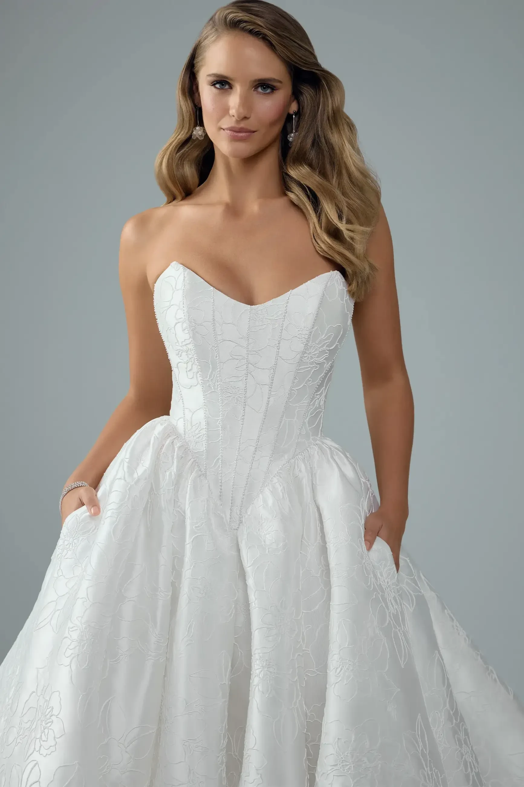 model is wearing a strapless wedding dress