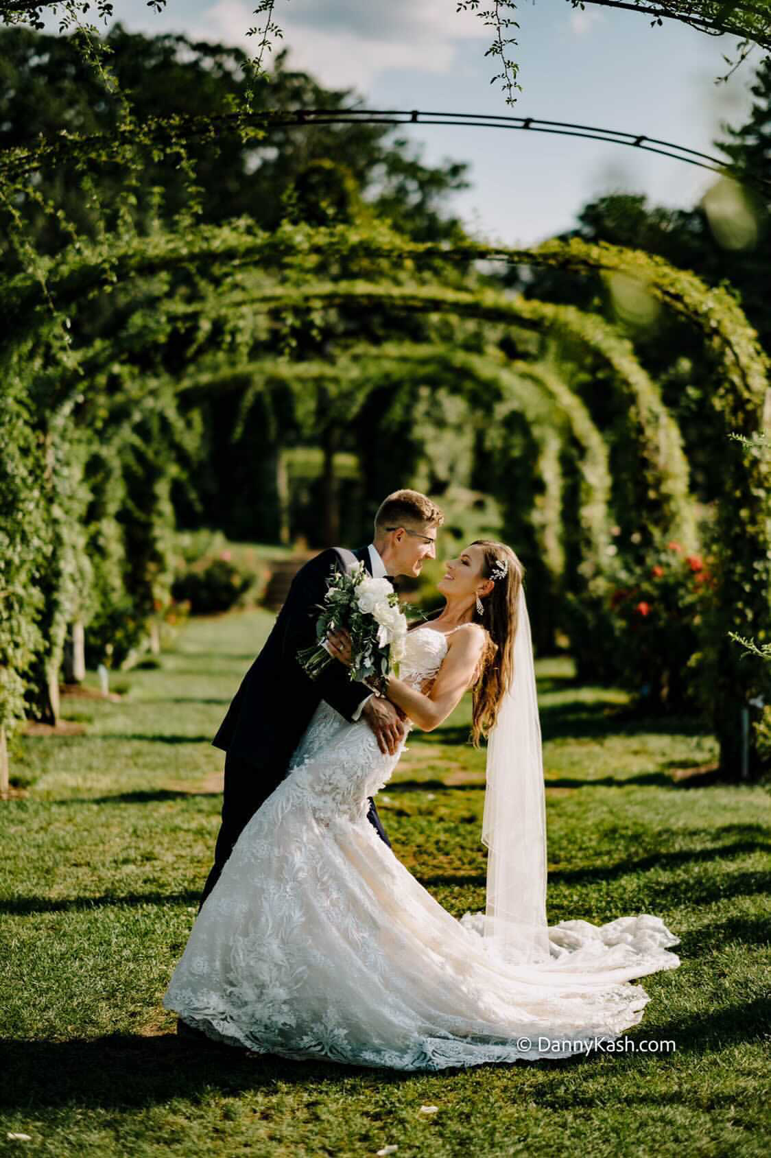 Photo of real bride and groom posing in the beautiful garden