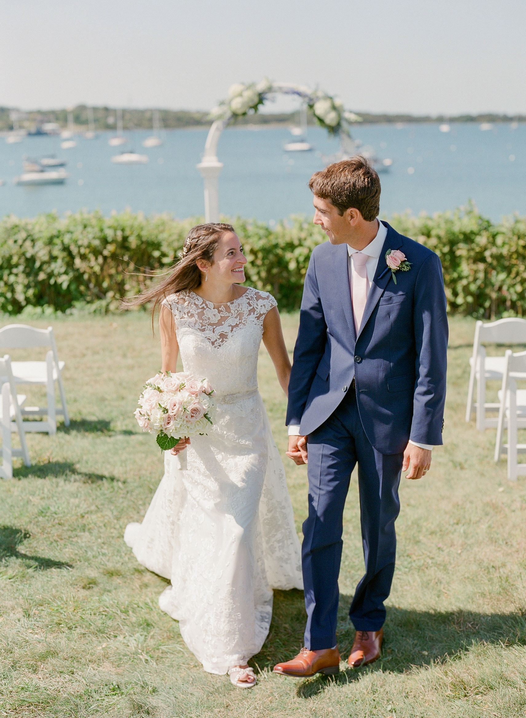 Photo of the bride and groom posing on the territory of the park and lake
